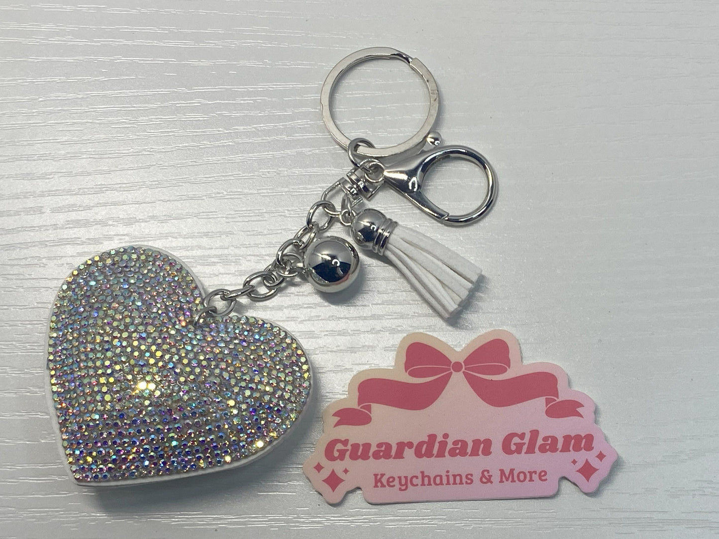 White heart-shaped rhinestone 
Sliver keychain with tassel  